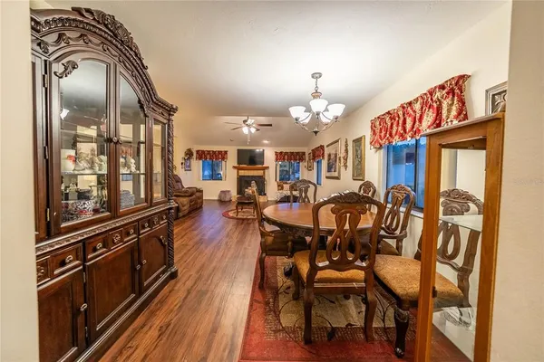 a view of a dining room with furniture and a chandelier