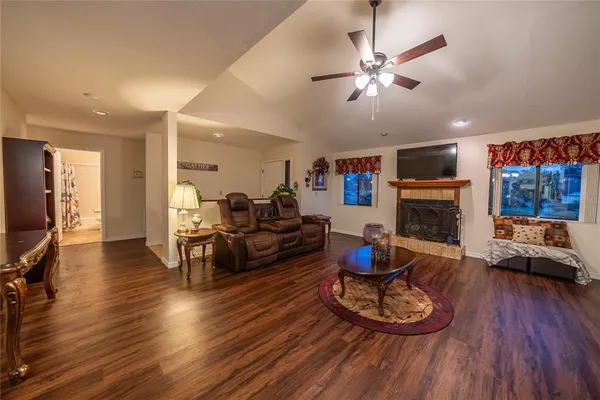 a living room with furniture a fireplace and a flat screen tv