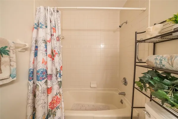 a bathroom with a bathtub and shower
