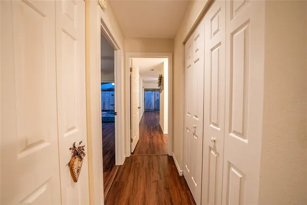 a view of a hallway with wooden floor and staircase