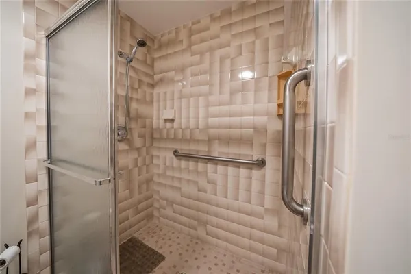a bathroom with a glass shower door