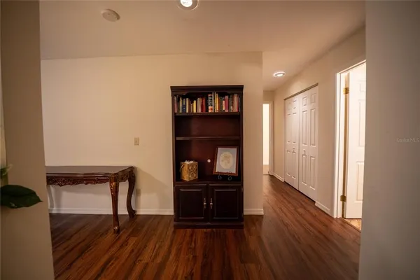 a view of a room with wooden floor and furniture