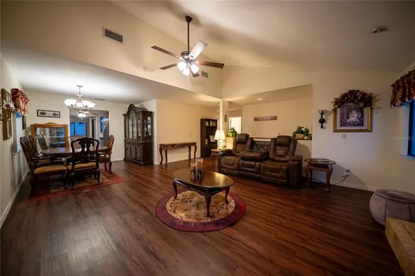 a living room with furniture and kitchen view