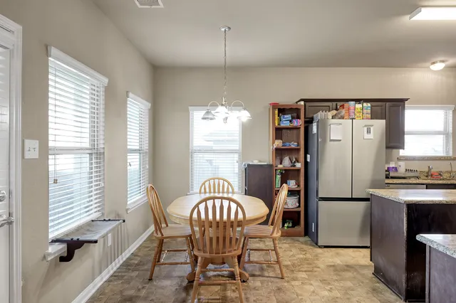 a dining room with furniture window and wooden floor