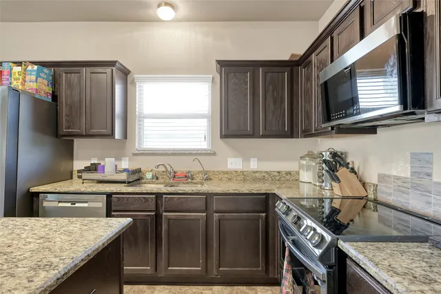 a kitchen with a stove and a sink