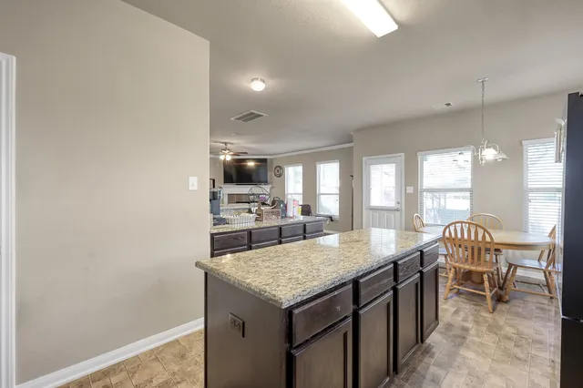 a living room with granite countertop furniture and a table