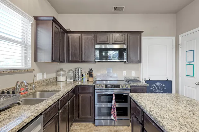 a kitchen with a stove and a sink