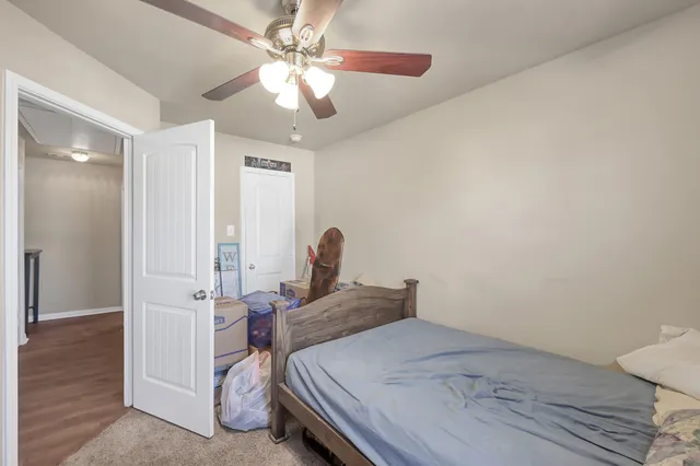 a bedroom with a bed and a chandelier