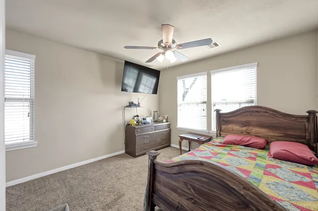 a bedroom with a bed and a window