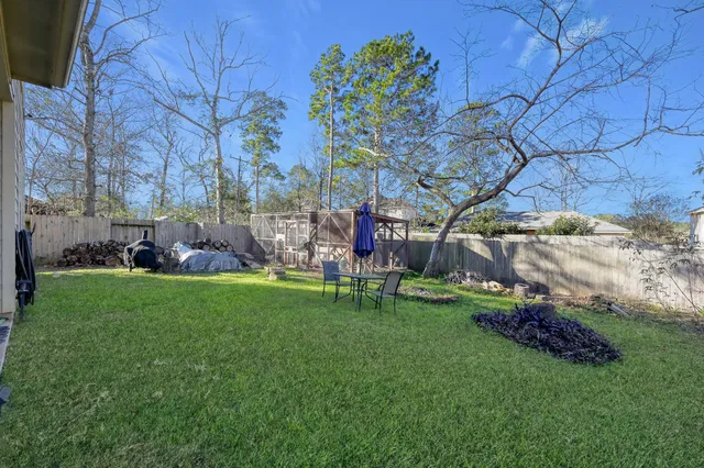 a backyard of a house with table and chairs