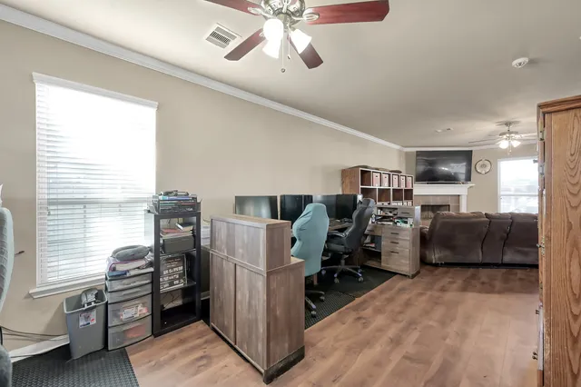a view of a workspace with furniture and a window