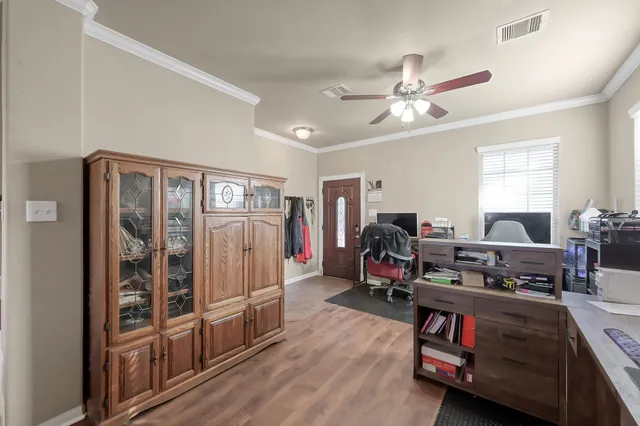 a living room with furniture a ceiling fan and a window