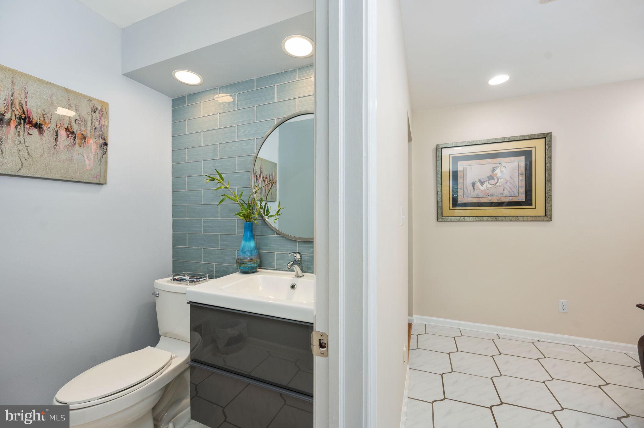 11105 Waddell Road Bumpass, VA 23024 - Photo 34 of 76 a bathroom with a toilet a sink and mirror