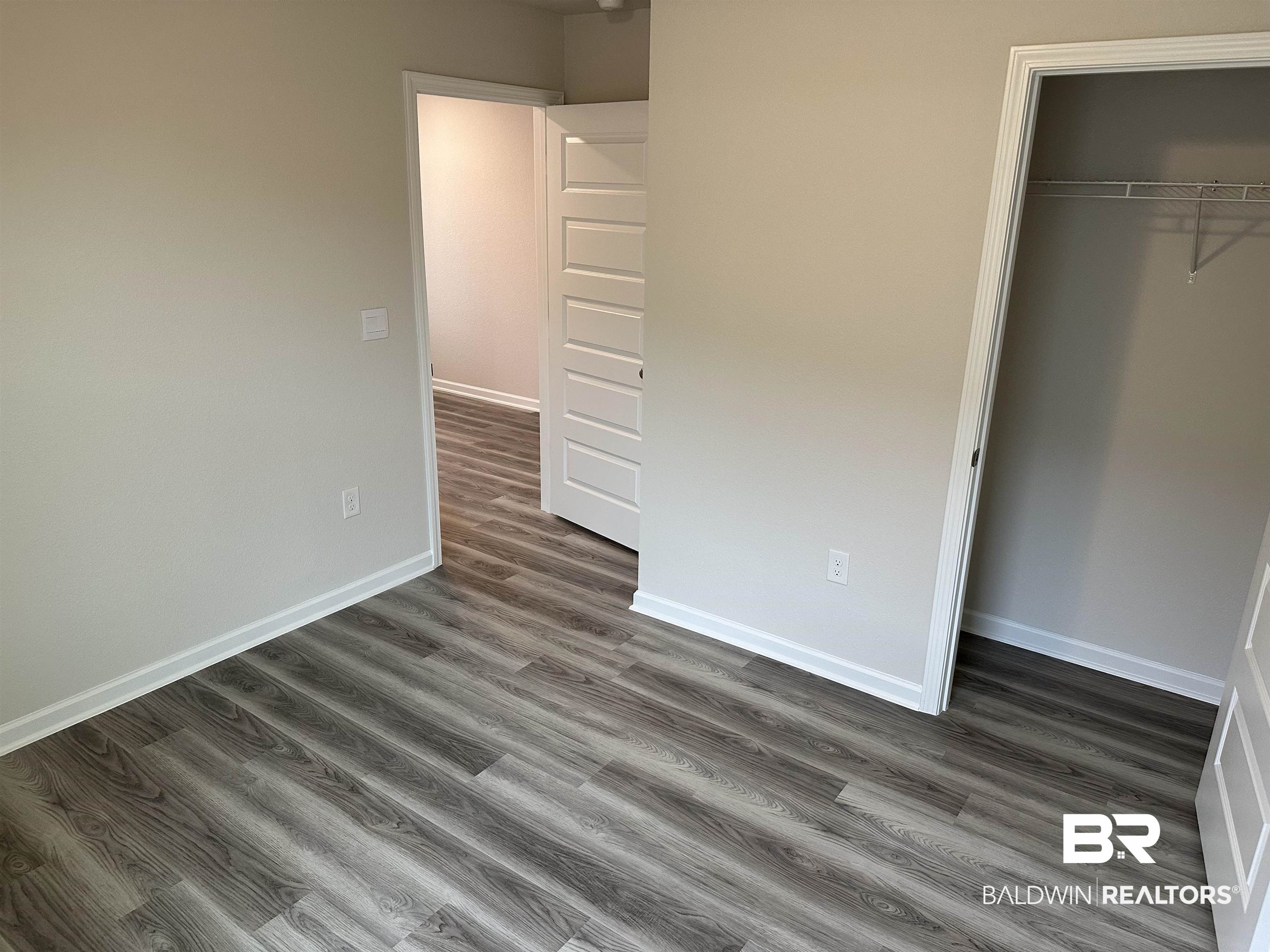 1238 Hayward Loop Foley, AL 36535 - Photo 11 of 46 Unfurnished bedroom featuring dark hardwood / wood-style flooring and a closet