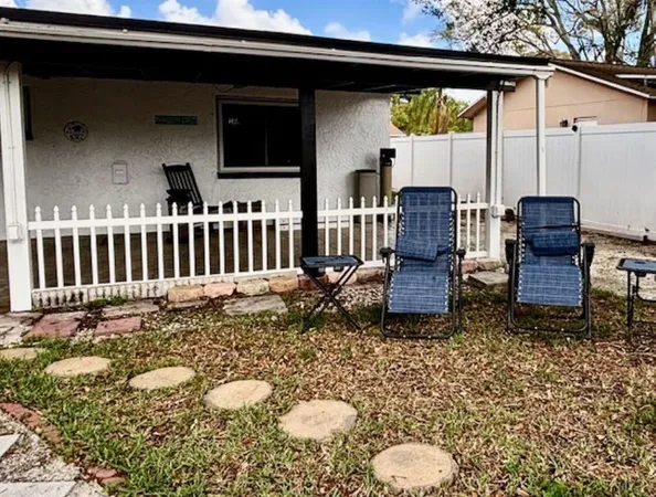 a view of two chairs in the patio