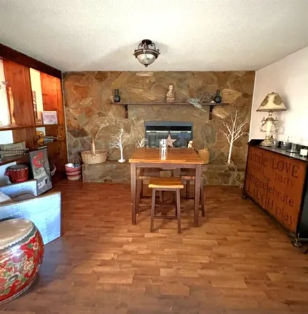 a dining room with furniture and a floor to ceiling window