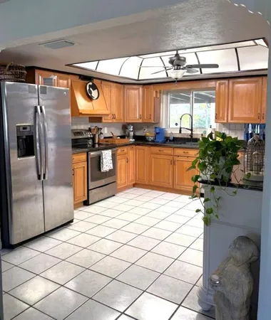 a kitchen with stainless steel appliances a refrigerator and a stove