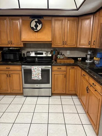 a kitchen with a stove a sink and cabinets
