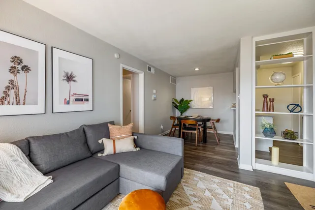 a living room with furniture and wooden floor