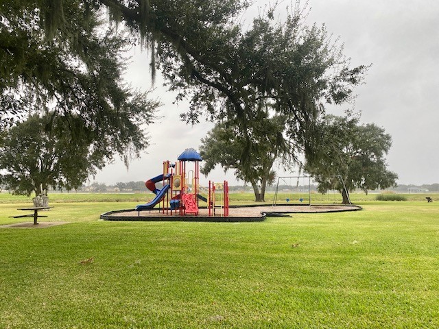 218 Cattle Drive Trail Angleton, TX 77515 - Photo 21 of 34 A close up view of the playground with swings and slide.