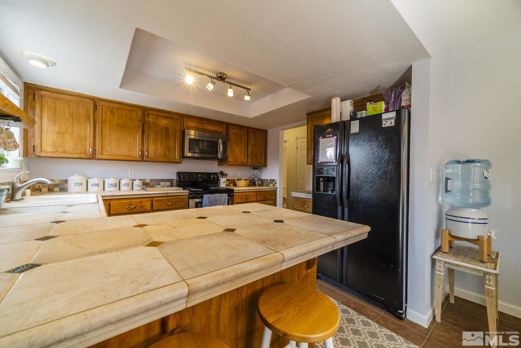 2510 Keystone Avenue Reno, NV 89503 - Photo 8 of 33 a kitchen with a refrigerator a stove a sink and cabinets