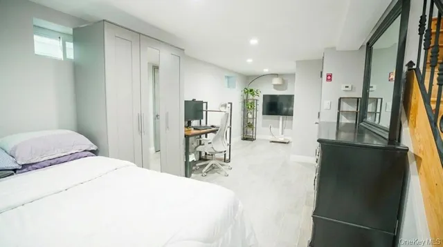 a bedroom with a bed and a flat screen tv