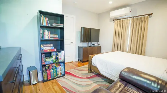 a bedroom with a bed and a bookshelf