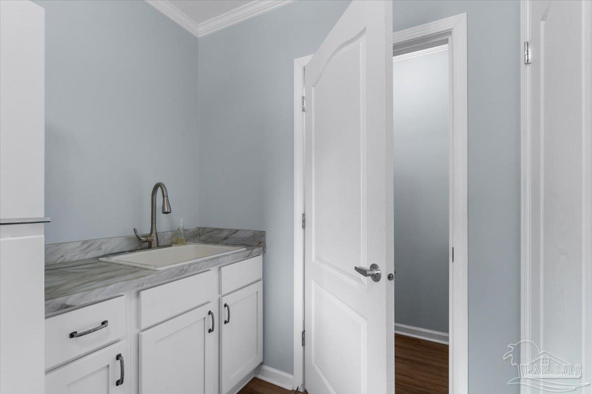 4955 Blue Ribbon Drive Milton, FL 32583 - Photo 22 of 32 a bathroom with a granite countertop sink and vanity