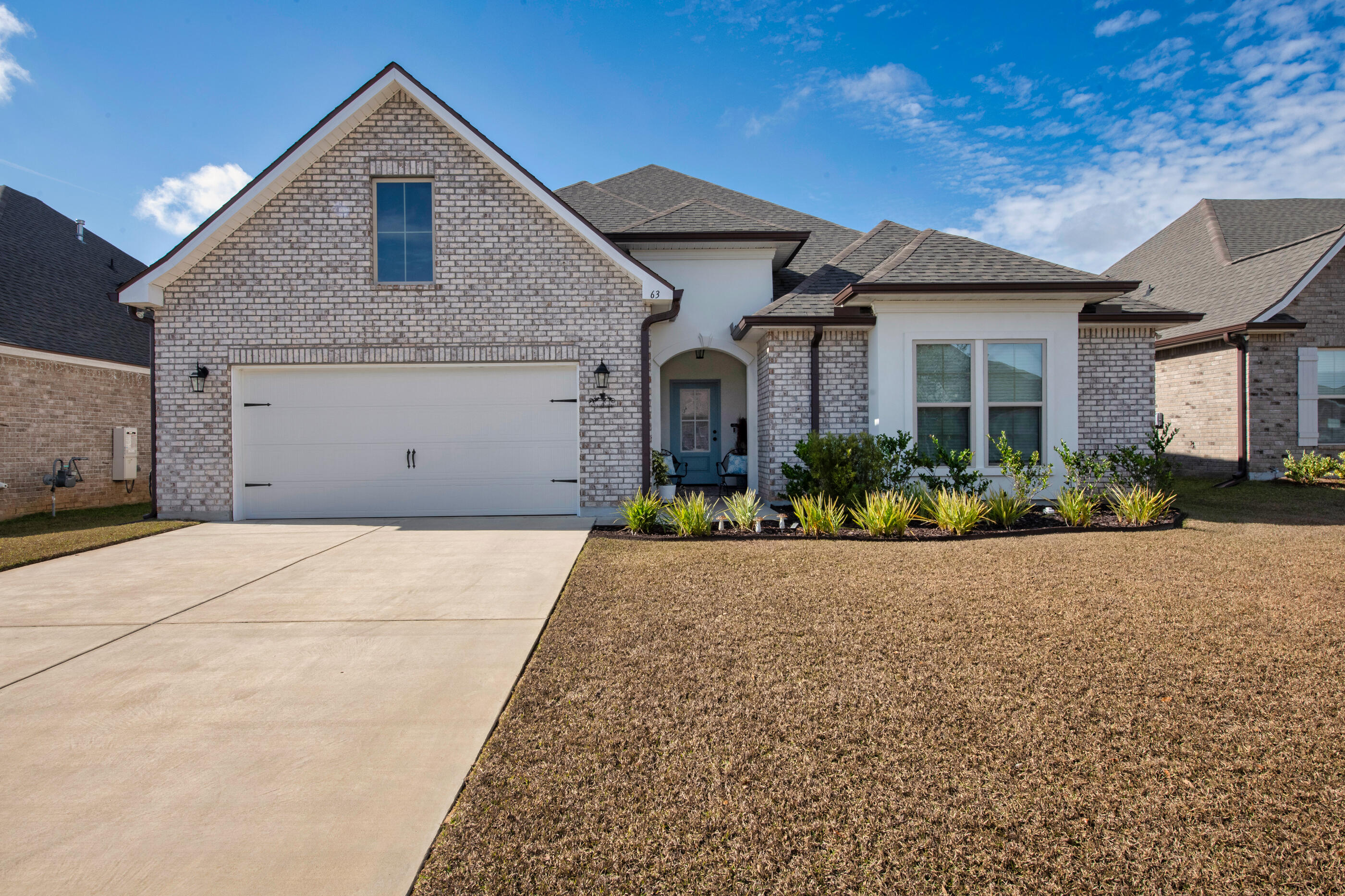 a view of garage yard and front view of a house