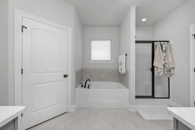 a view of walk in closet with clothes