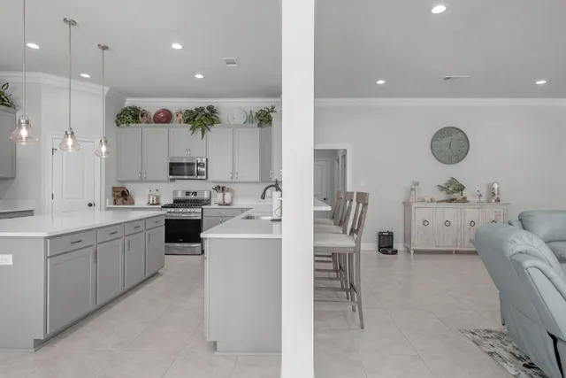a kitchen with kitchen island a sink stainless steel appliances and cabinets