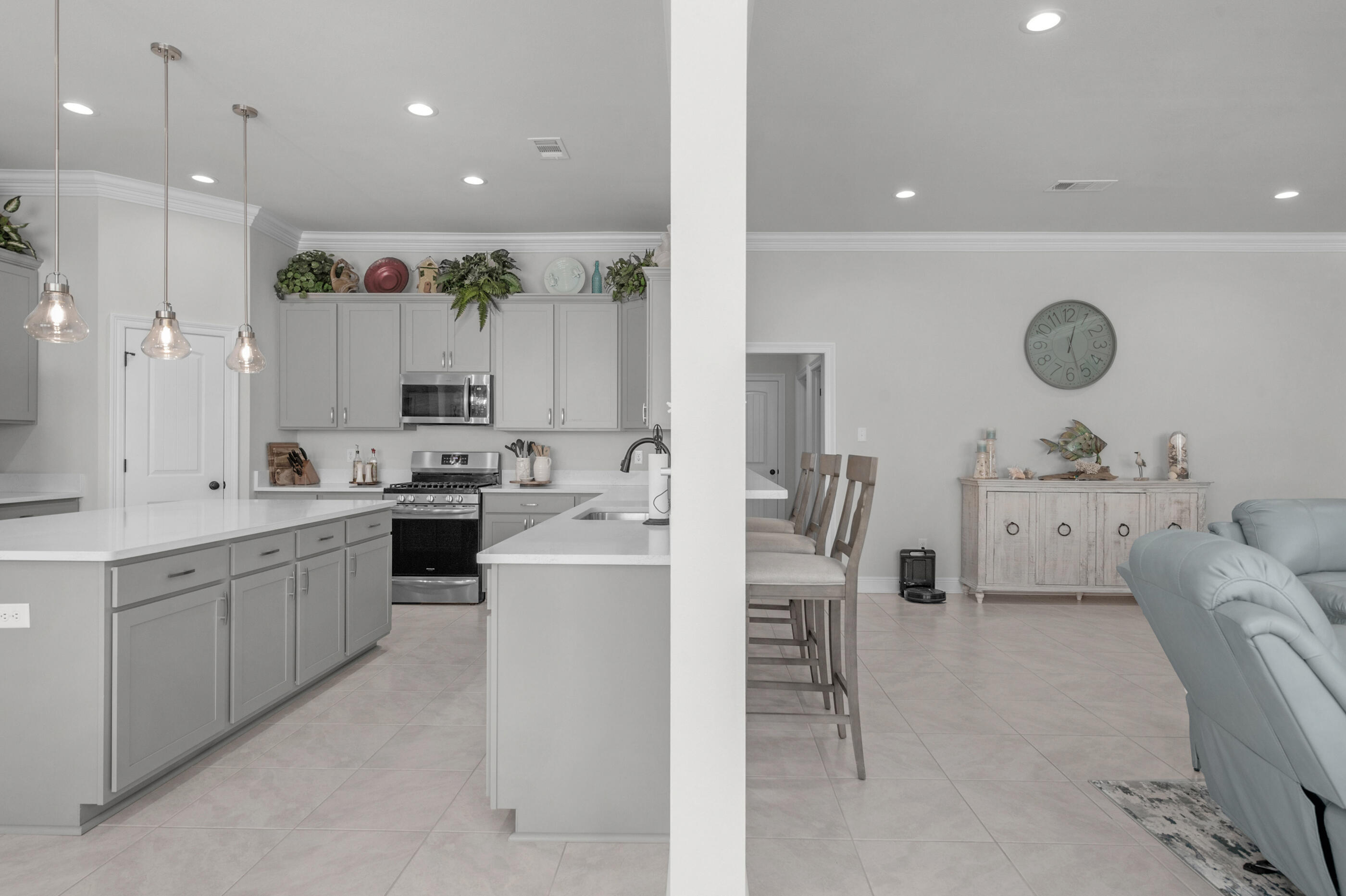 63 Alley Oak Lane Freeport, FL 32439 - Photo 24 of 50 a large kitchen with cabinets a sink a window and a clock