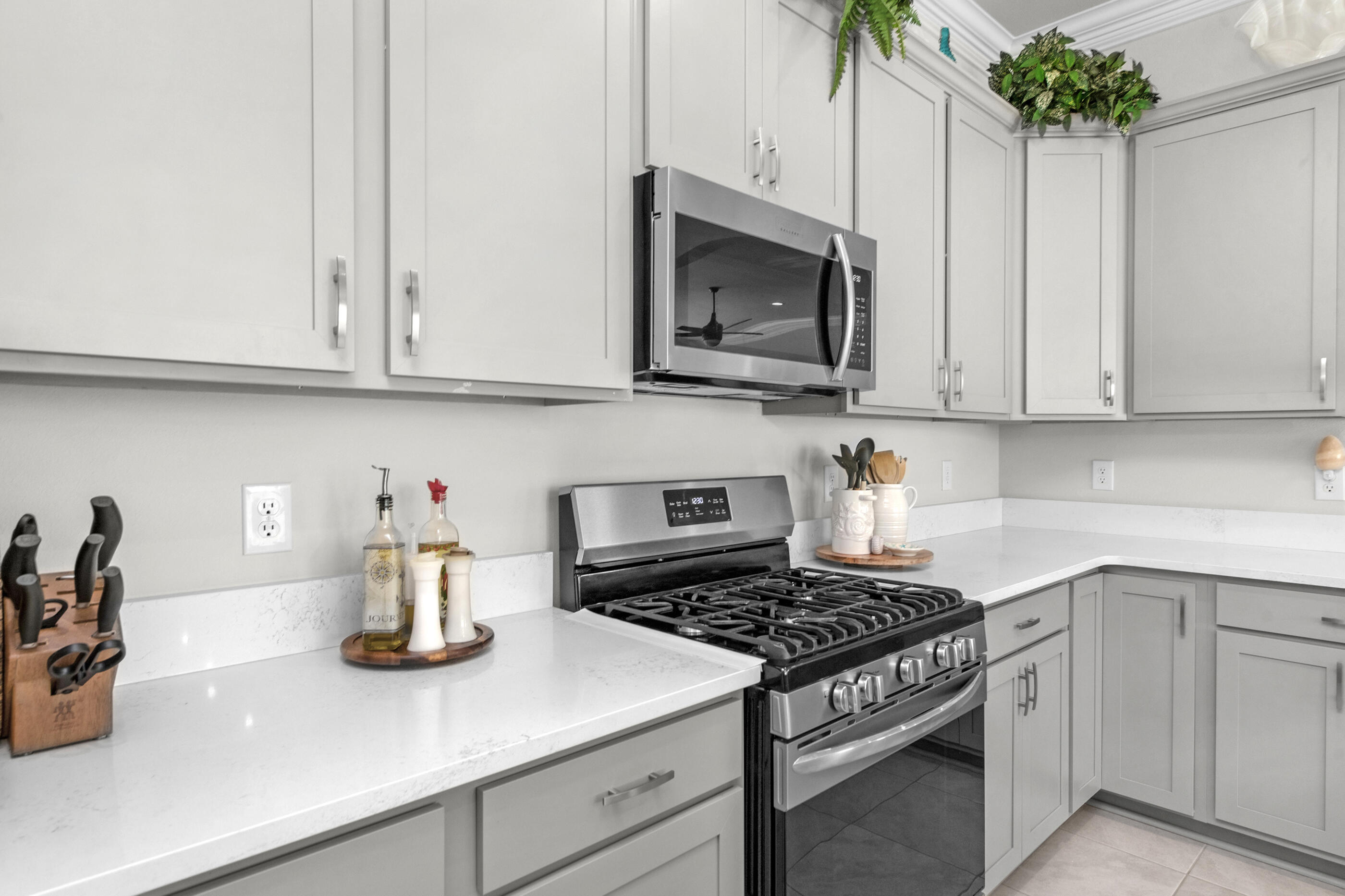 63 Alley Oak Lane Freeport, FL 32439 - Photo 28 of 50 a kitchen with stainless steel appliances granite countertop white cabinets and a stove top oven