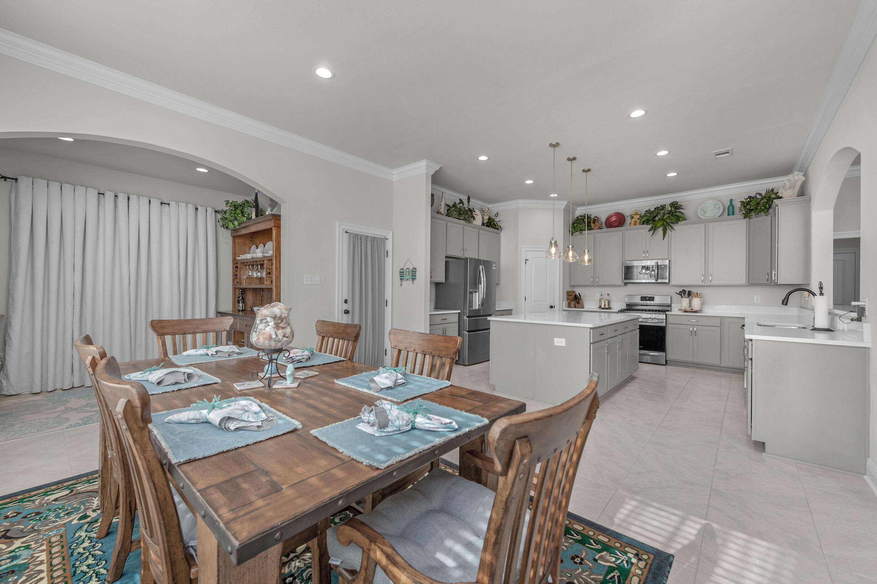 63 Alley Oak Lane Freeport, FL 32439 - Photo 33 of 50 a open dining room with kitchen island stainless steel appliances wooden floor dining table and chairs