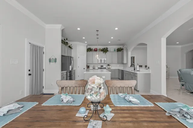 a kitchen with stainless steel appliances a stove and white cabinets
