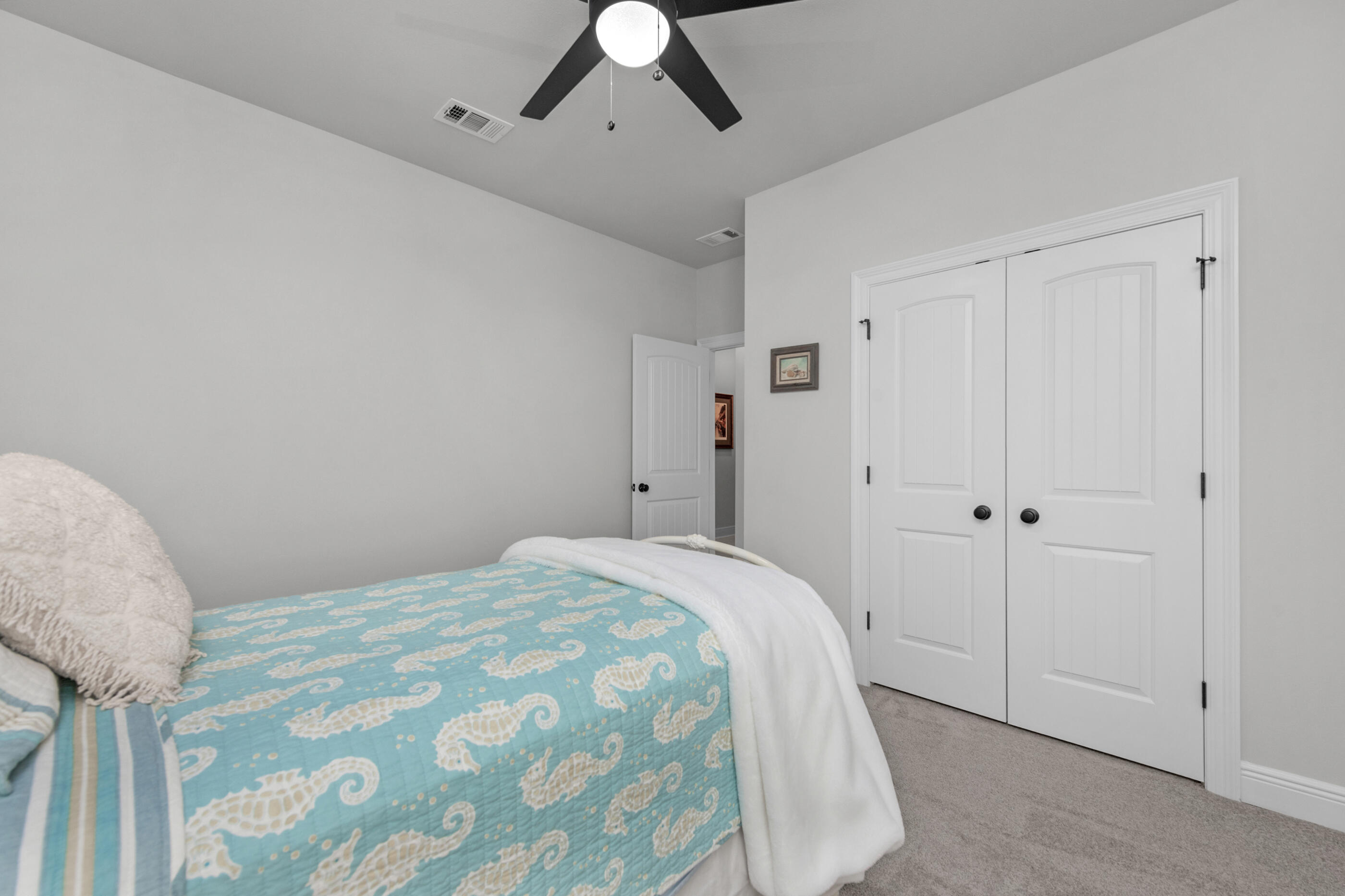 63 Alley Oak Lane Freeport, FL 32439 - Photo 38 of 50 a bedroom with a bed and a chandelier