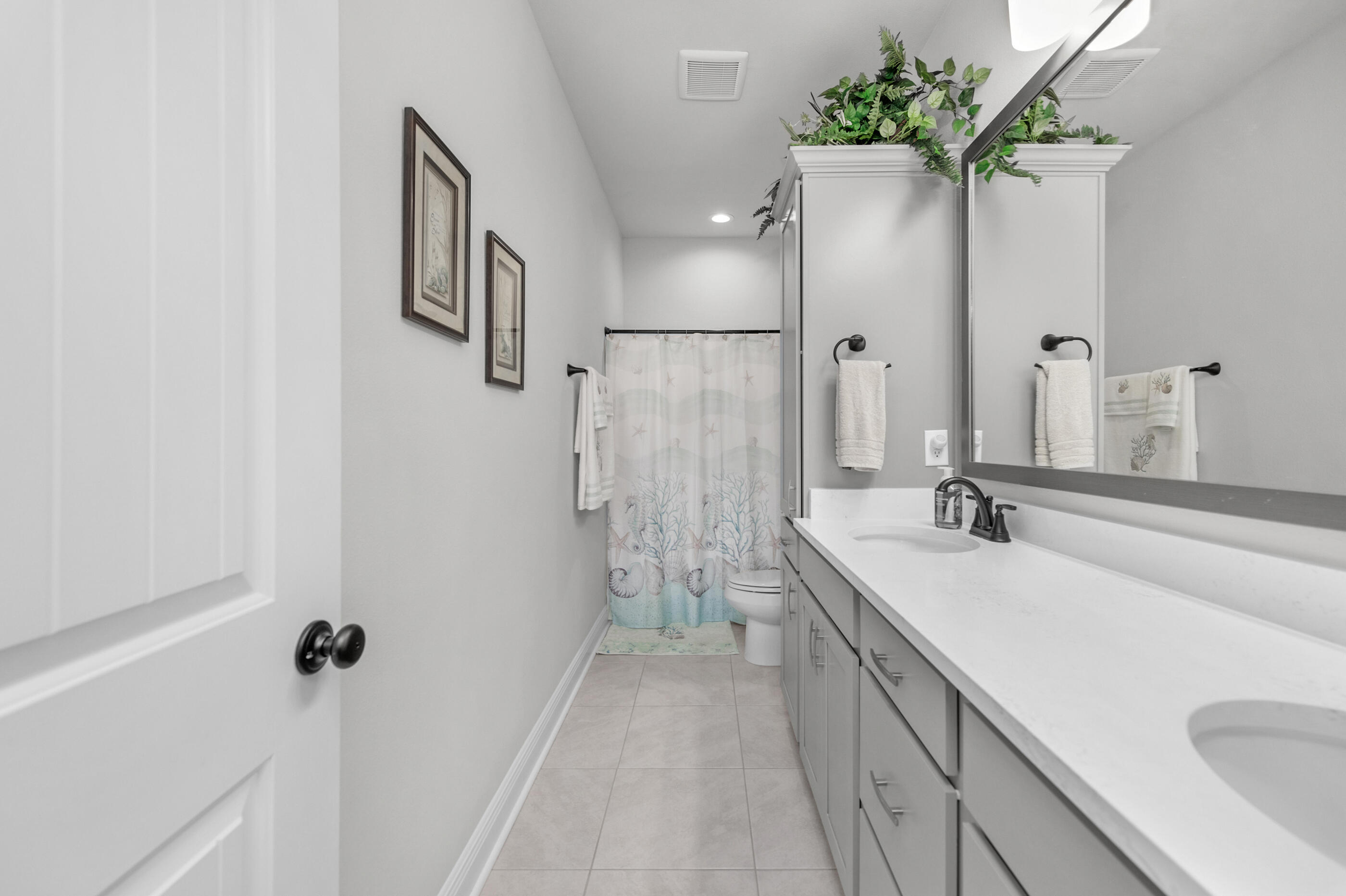 63 Alley Oak Lane Freeport, FL 32439 - Photo 39 of 50 a spacious bathroom with a double vanity sink a large mirror a bathtub and shower