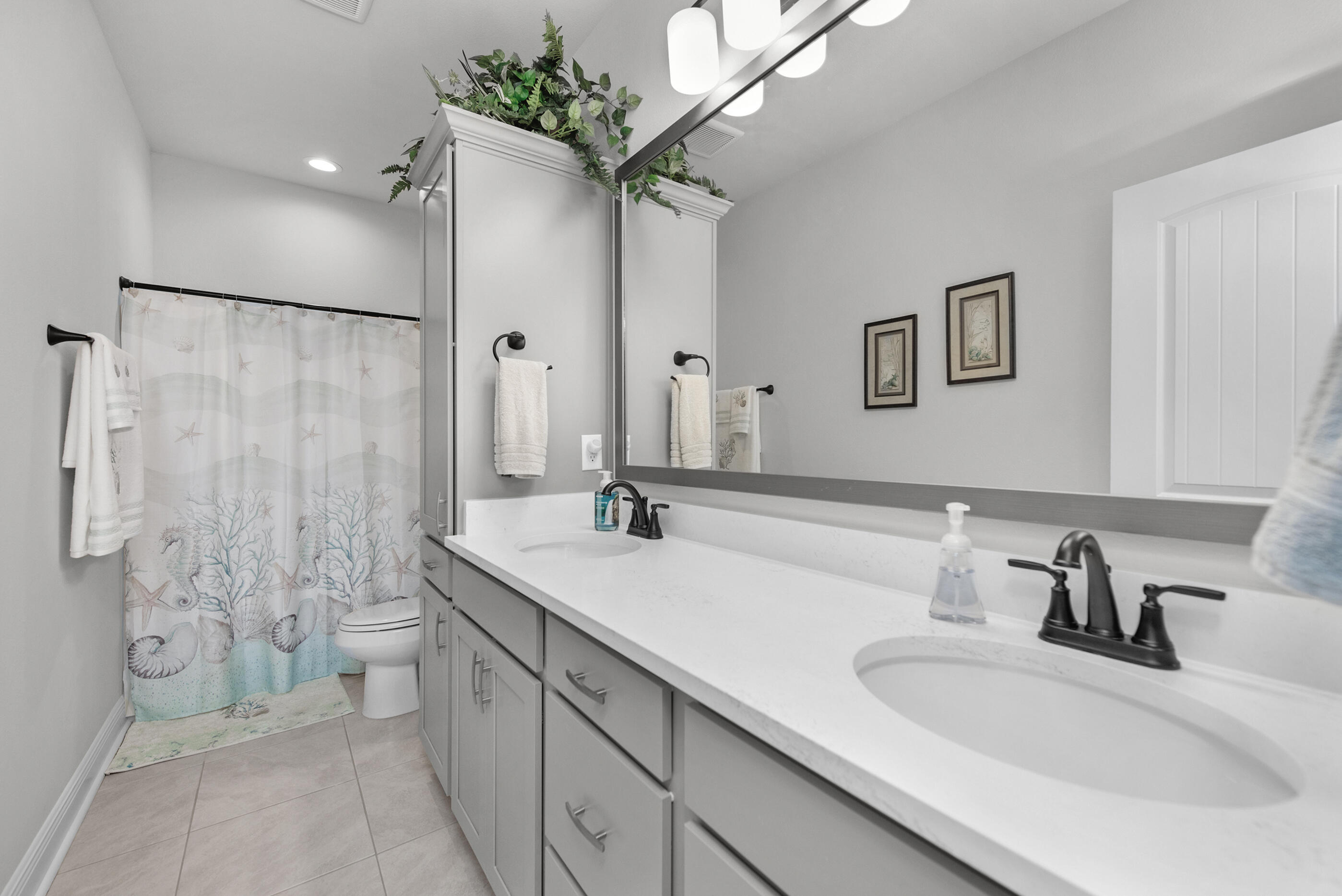 63 Alley Oak Lane Freeport, FL 32439 - Photo 40 of 50 a bathroom with a double vanity sink mirror and toilet