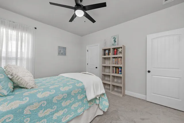 a view of a livingroom with furniture and a ceiling fan