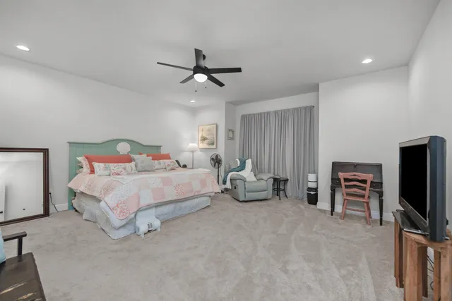 a bedroom with furniture and a flat screen tv