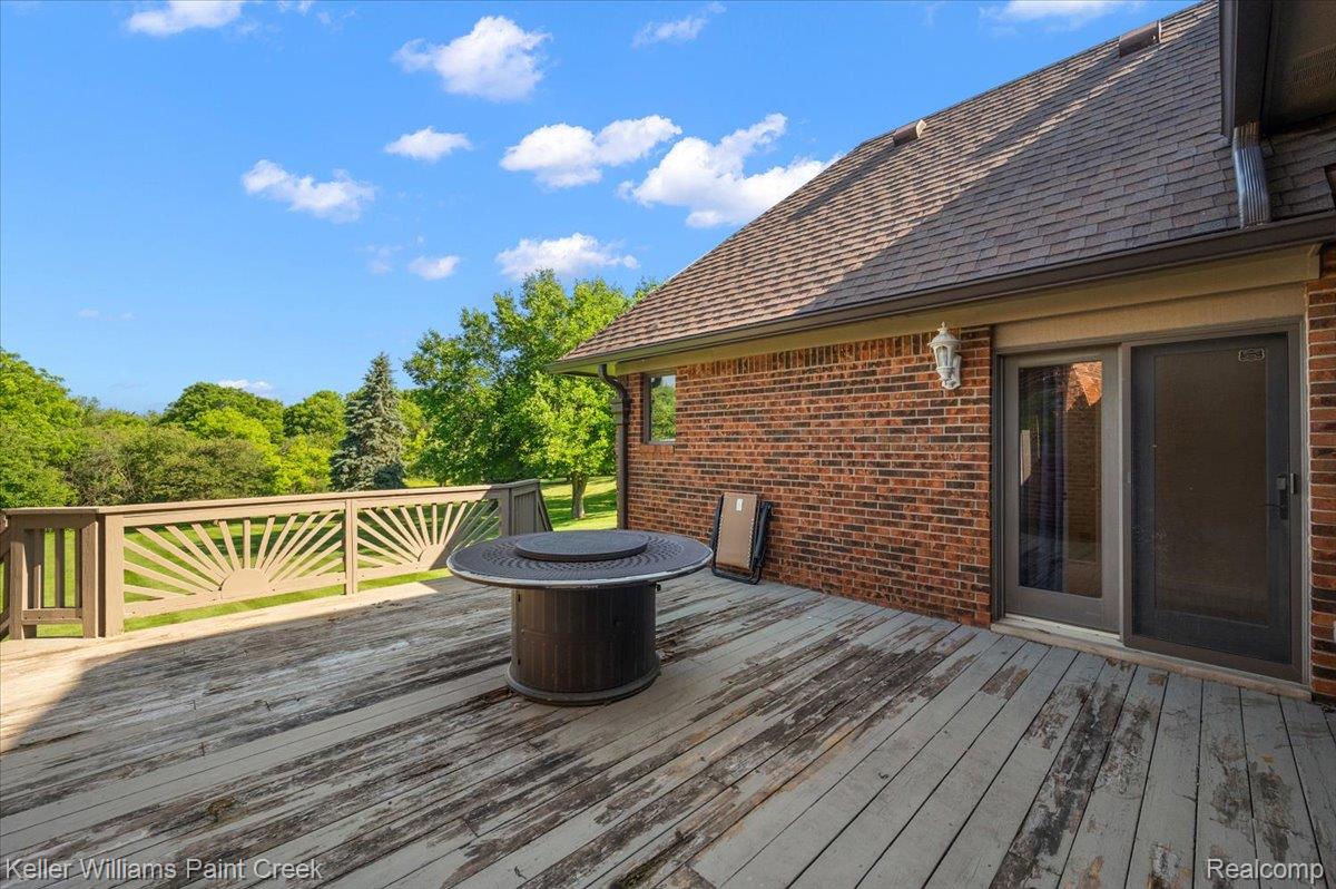 69069 Campground Road Romeo, MI 48065 - Photo 16 of 78 Spacious outdoor deck with decorative railing, providing direct access to the interior via a sliding glass door