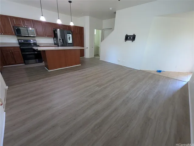 a view of kitchen with cabinets and wooden floor