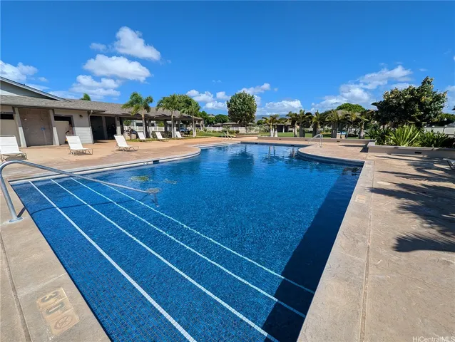 a view of swimming pool with outdoor seating