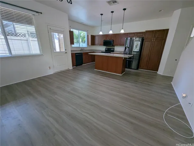 a view of kitchen with sink microwave and refrigerator