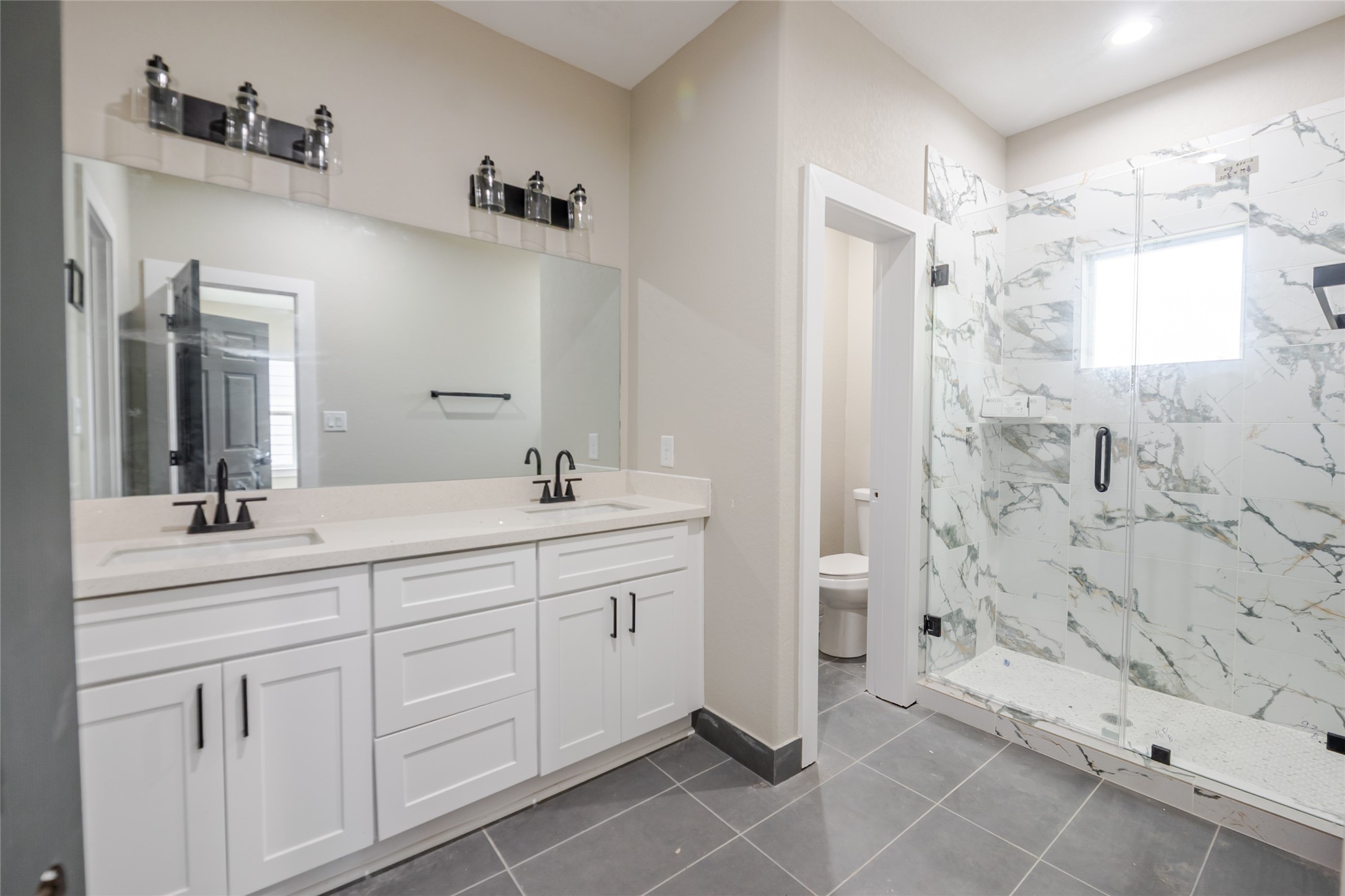 8709 Westcott Road, Unit A AND B Houston, TX 77016 - Photo 14 of 14 a spacious bathroom with a shower sink and mirror