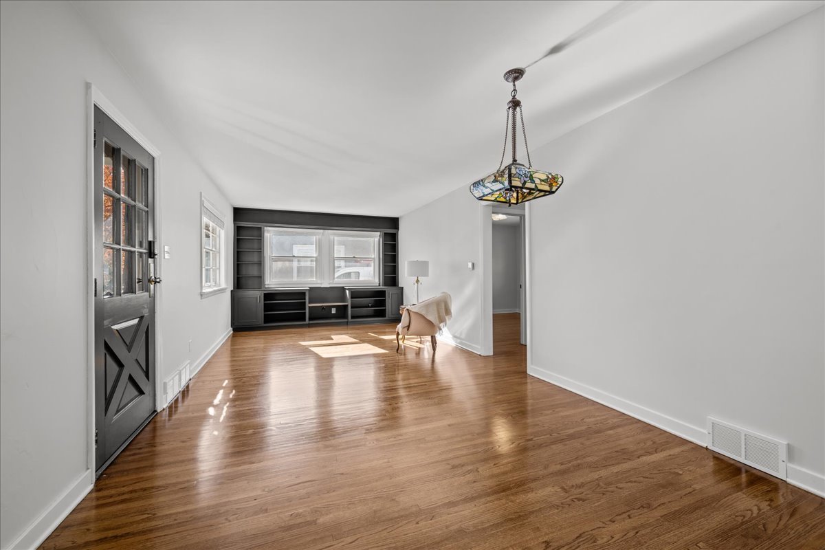 425 Ingleside Avenue Aurora, IL 60506 - Photo 4 of 13 a view of a room with wooden floor fireplace and windows