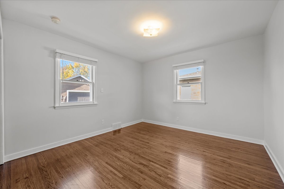 425 Ingleside Avenue Aurora, IL 60506 - Photo 8 of 13 a view of empty room with wooden floor and fan