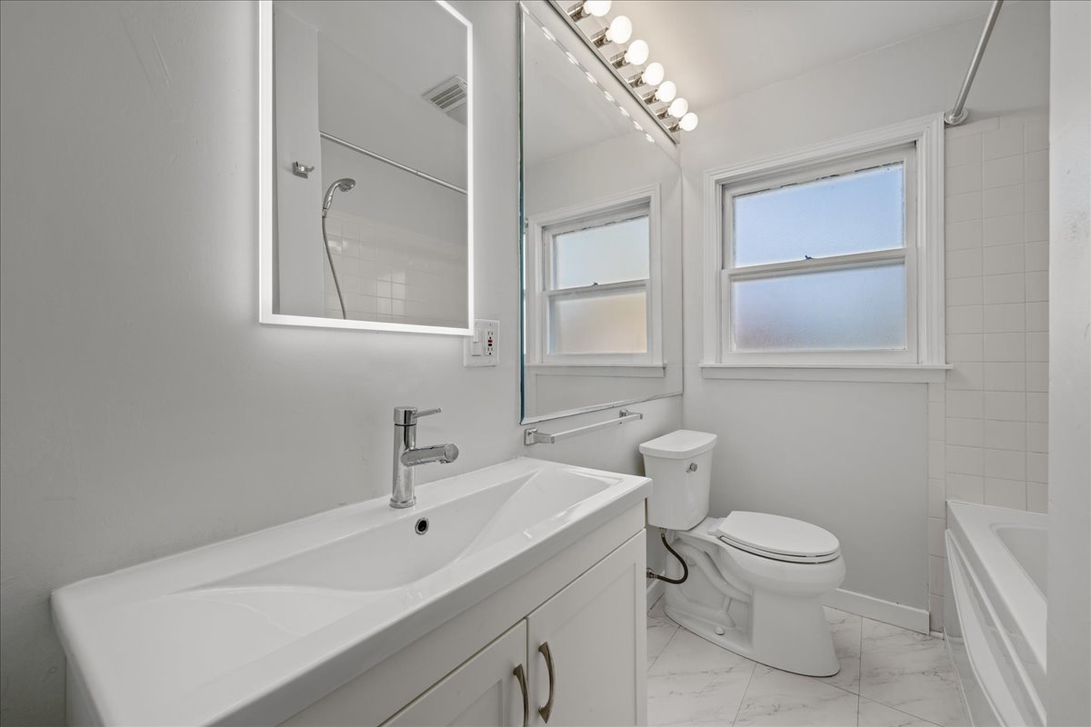 425 Ingleside Avenue Aurora, IL 60506 - Photo 9 of 13 a bathroom with a toilet sink and mirror