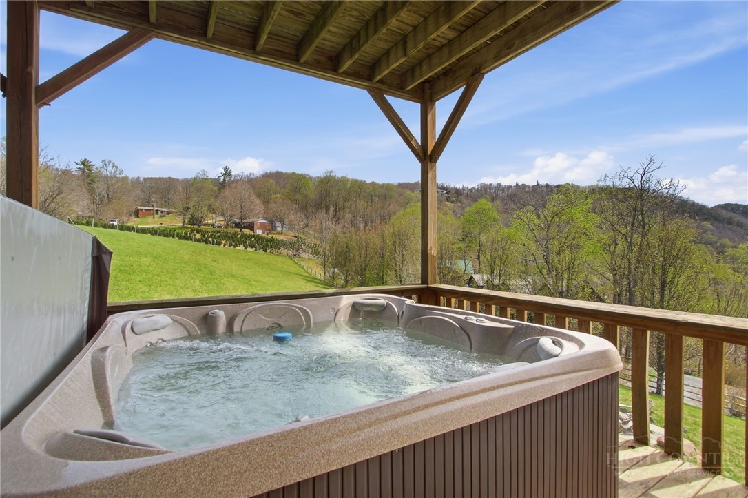 2081 Blackberry Road Boone, NC 28607 - Photo 8 of 45 a view of a swimming pool with a table under an umbrella