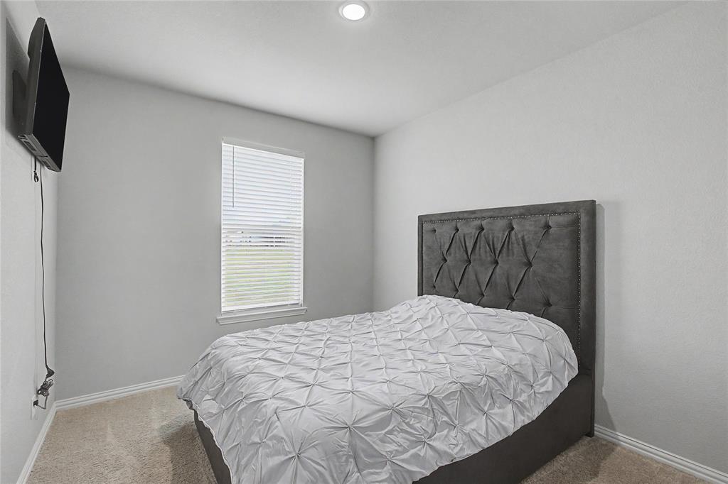 185 Chester Road Springtown, TX 76082 - Photo 28 of 40 Neutral-toned room featuring a single window with blinds, recessed ceiling lighting, and carpeted flooring